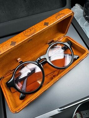 MCM Black Round eyeglasses with logo on frame arms. Very light purple tint. Rx